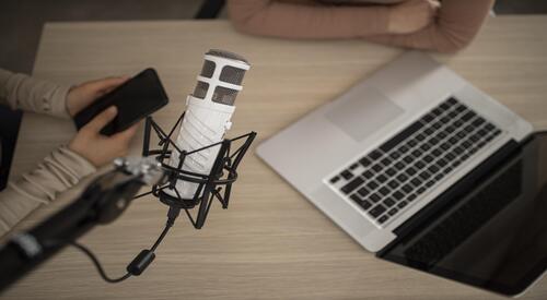 Table with several microphones on it for an interview 